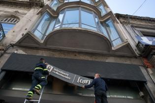Colocación de cartel en el Edificio del CdF